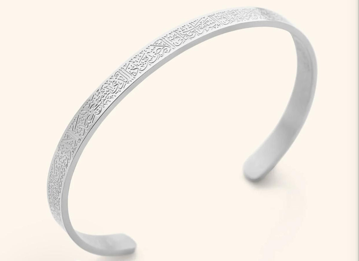 Elegant silver cuff bracelet with engraved Arabic calligraphy patterns